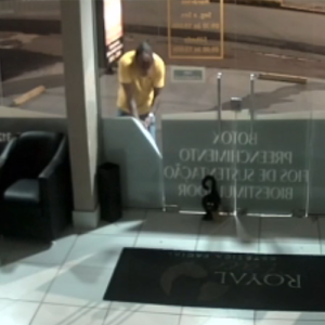 Câmera flagra homem danificando fachada de clínica